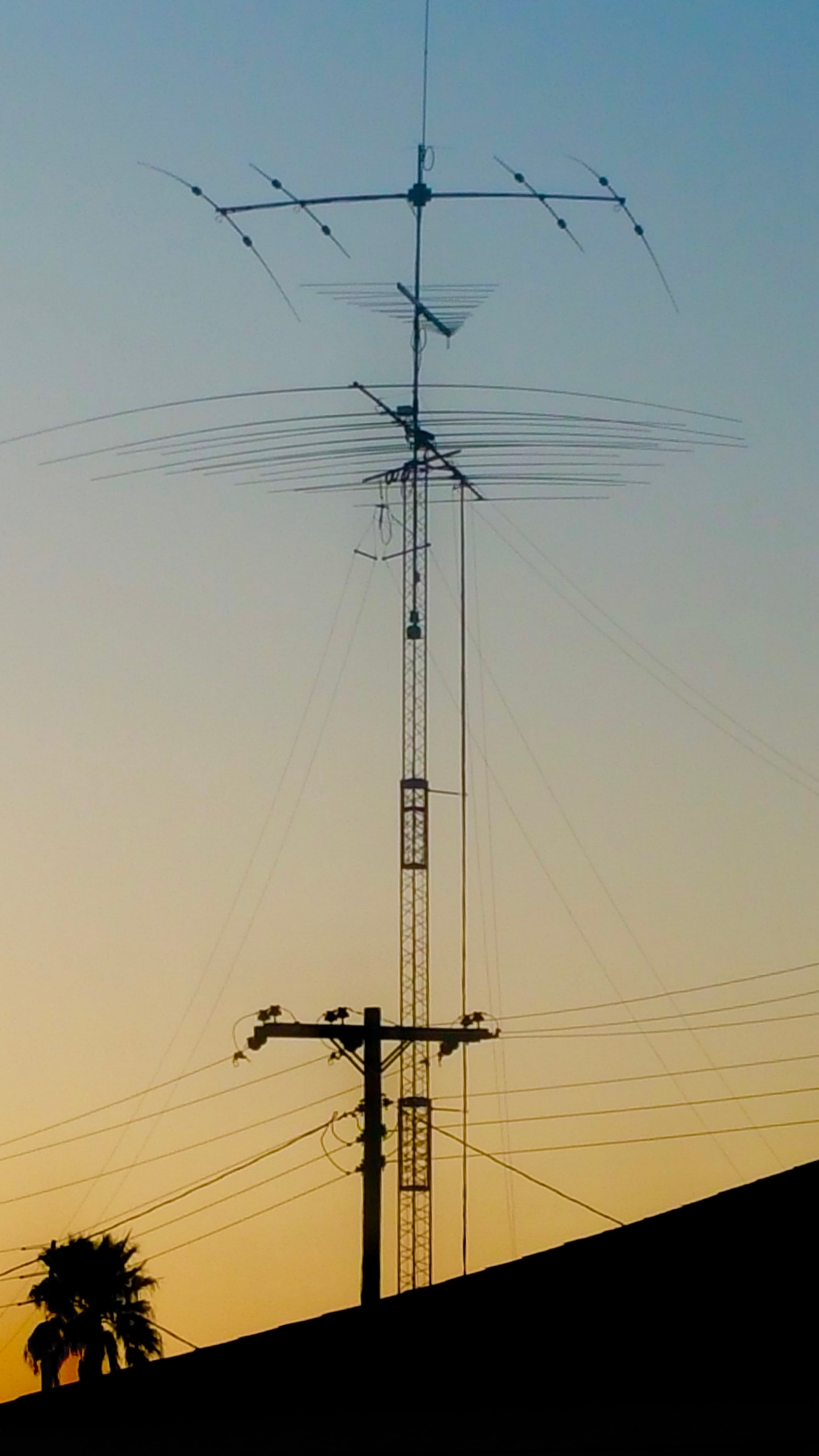 Antenna tower silhouette against a sunset sky